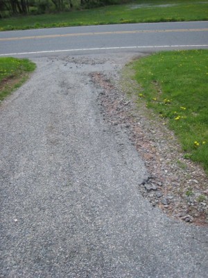 damage to our tar and chip driveway--a very heavy rain storm washed part of it away